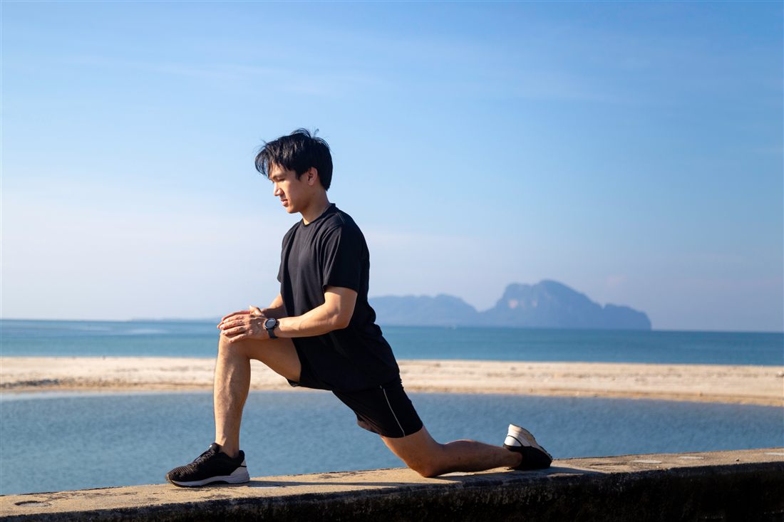 A man stretching outdoors before a run