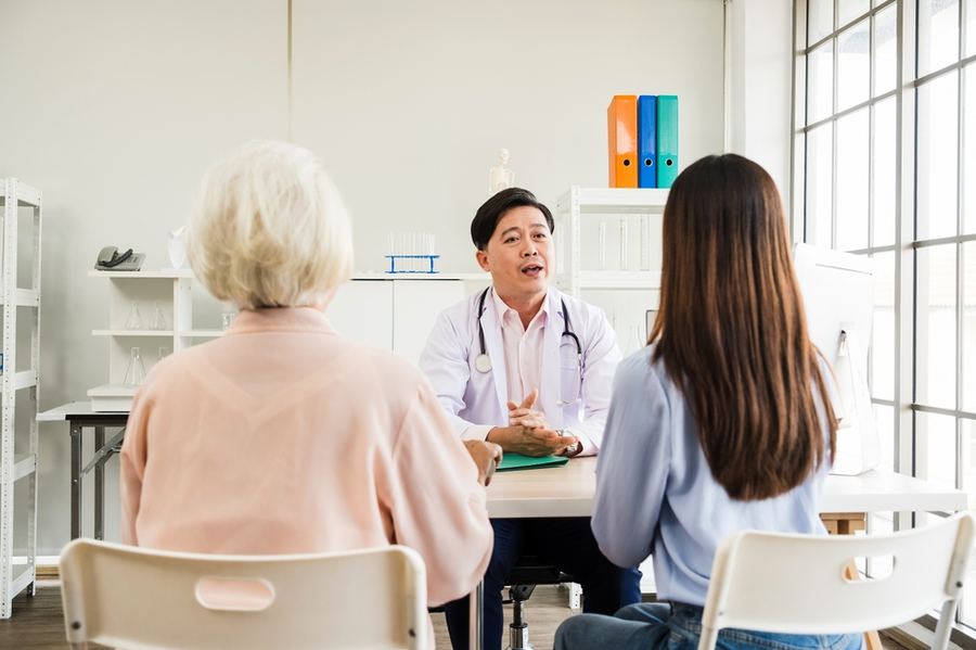 A doctor consulting with a patient and family member
